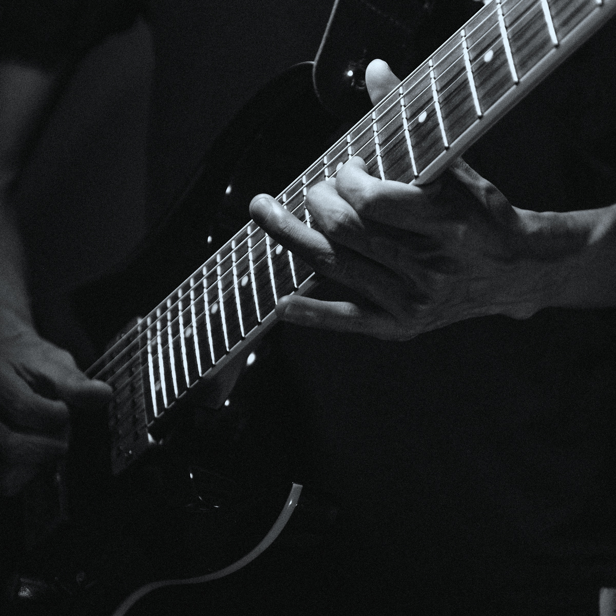 Close-up Photo of Person playing electric Guitar 